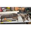 Image 1 : TABLE OF ASSORTED VINTAGE TOOLS: SAW BLADES, ADZES, TROWELS, HAND CRANK DRILL & MORE