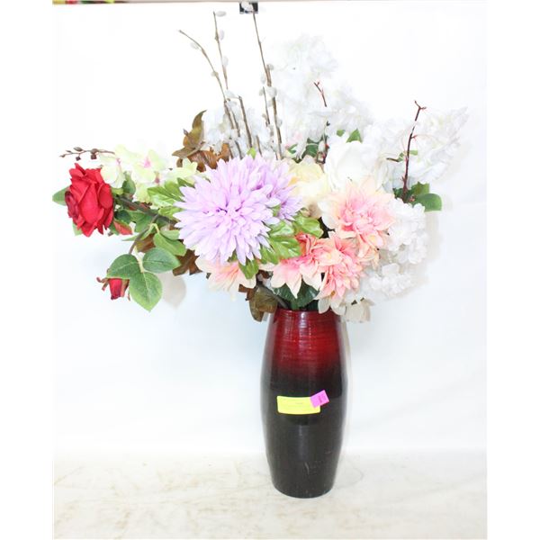 RED VASE FULL OF ARTIFICIAL FLOWERS