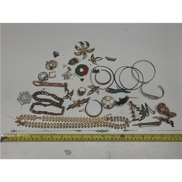 Large collection of assorted vintage costume jewelry, including brooches, necklaces, and bracelets.