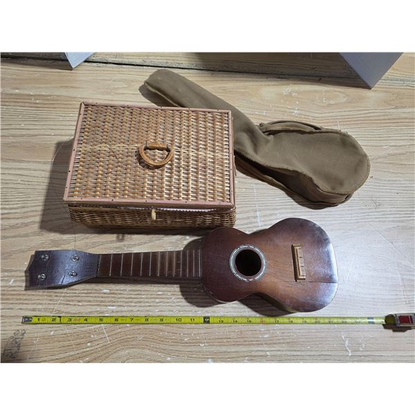 Broken ukelele and wicker basket
