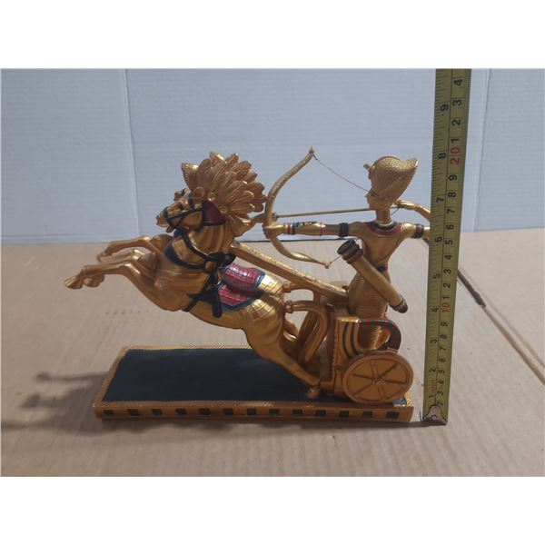 Egyptian-style chariot statue depicting a pharaoh, often identified as King Ramses II, aiming a bow.