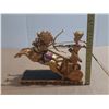 Image 1 : Egyptian-style chariot statue depicting a pharaoh, often identified as King Ramses II, aiming a bow.