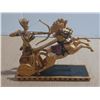 Image 4 : Egyptian-style chariot statue depicting a pharaoh, often identified as King Ramses II, aiming a bow.