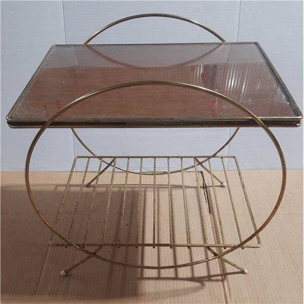 Vintage Mid-Century Modern table features a gold-toned brass tubular design with a smoked glass top 