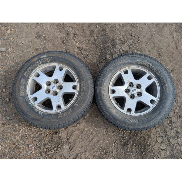 (2) Radial Wild Country 235/70 Tires w/ Rim