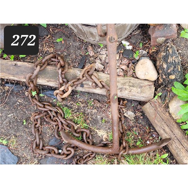 Antique nautical anchor with heavy chain.