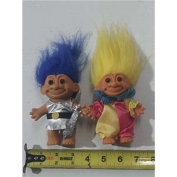 Vintage Russ Troll dolls feature unique costumes, including a blue-haired troll dressed as a knight 