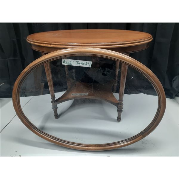 Small oval table with removeable glass top framed in wood. Room in between for embroidered piece, do