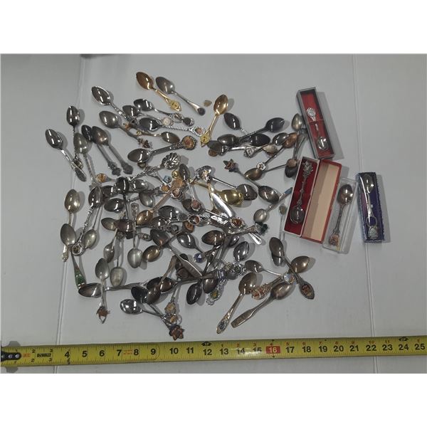 This is a large collection of vintage souvenir spoons featuring various travel destinations, states,