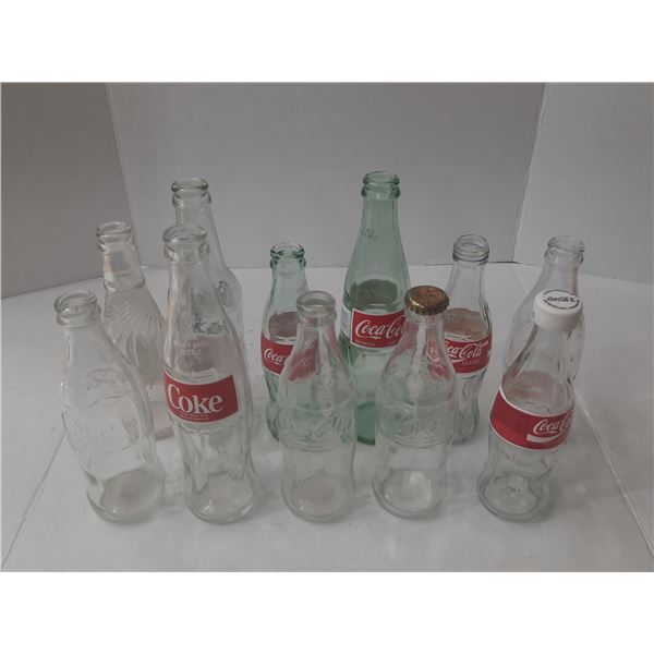 Vintage glass Coca-Cola bottles in green and clear glass.