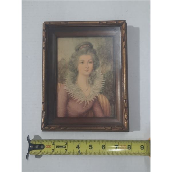 Vintage-style portrait painting/photo of a woman in an ornate, dark wood frame.