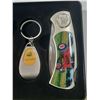 Image 4 : John Deere branded set includes a folding pocket knife with tractor artwork, a themed keychain, and 
