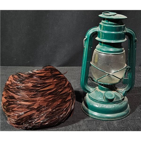 Green Metal Hurricane Lantern and Feathered Hat with Brown Plumage