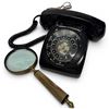 Image 1 : Vintage Black Rotary Dial Telephone Paired with a Brass-framed Magnifying Glass