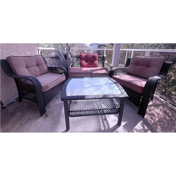 Four-Piece Black Wicker Patio Furniture Set with Cushions and Glass-Topped Table