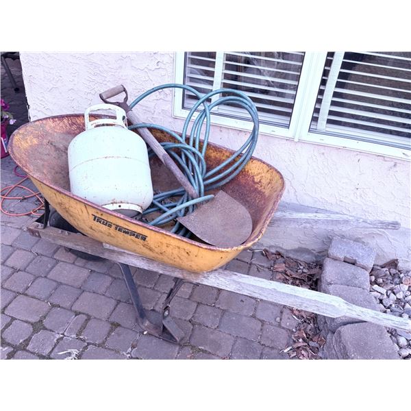 Yellow Metal Wheelbarrow with Propane Tank, Garden Hose, and Shovel