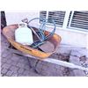 Image 1 : Yellow Metal Wheelbarrow with Propane Tank, Garden Hose, and Shovel