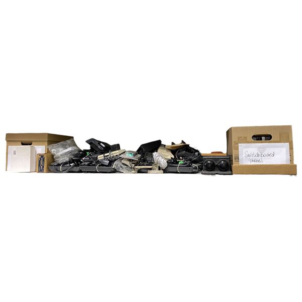 Shelf of Assorted Vintage Telephones and Power Adapters