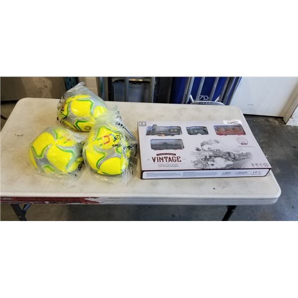 3 NEW SOCCER BALLS AND TRAIN SET