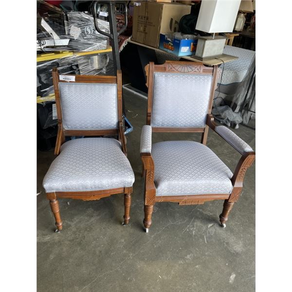 PAIR OF CARVED WOOD AND BLUE FABRIC CHAIRS W/ WHEELS