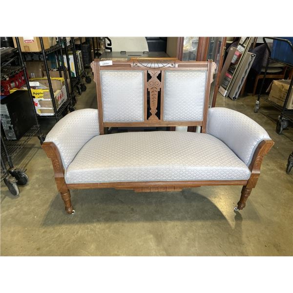 VINTAGE CARVED WOOD AND BLUE FABRIC LOVE SEAT  W/ WHEELS