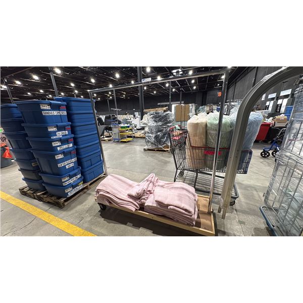 ROLLING GARMENT RACK WITH PINK HOSPITAL BLANKETS
