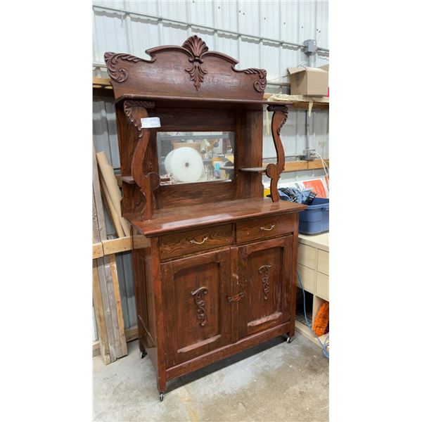Antique Oak Sideboard with Carved Pediment, Beveled Mirror, and Casters 44 x 86 x 20