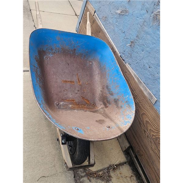 Blue Metal Wheelbarrow with Rust and Signs of Wear