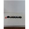 Image 1 : (5) Normal Pucks, (1) Foam Puck with Rubber Wristband As-Is