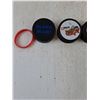 Image 3 : (5) Normal Pucks, (1) Foam Puck with Rubber Wristband As-Is
