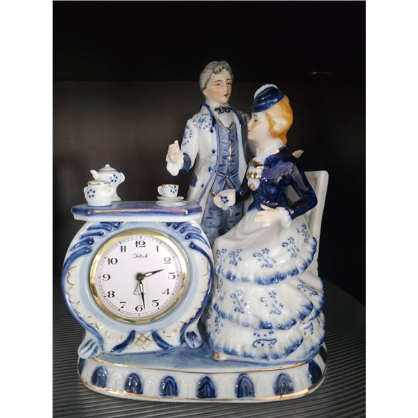 Porcelain Figurine Clock with Romantic Couple and Tea Set Design