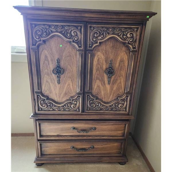 Wooden Armoire with Ornate Panels and Storage Drawers