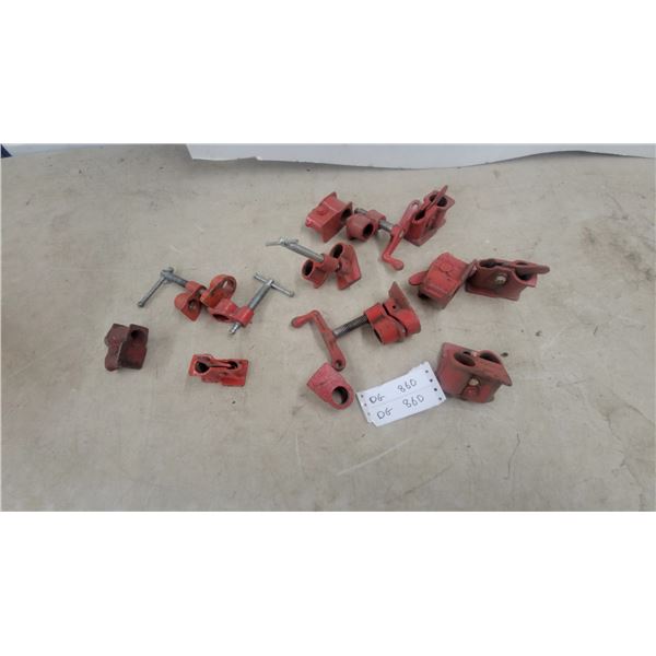 Collection of Red Cast Iron Pipe Clamp Fixtures and Heads