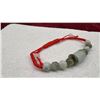 Image 4 : Natural Burmese Multi-Color Jadeite 53.00 Carat 11-Piece Adjustable Red Cord Bracelet, 2-3"