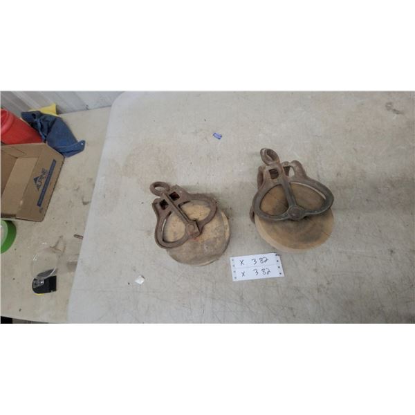 Two Vintage Cast Iron and Wood Single-Sheave Barn Pulleys with Integrated Eyelets