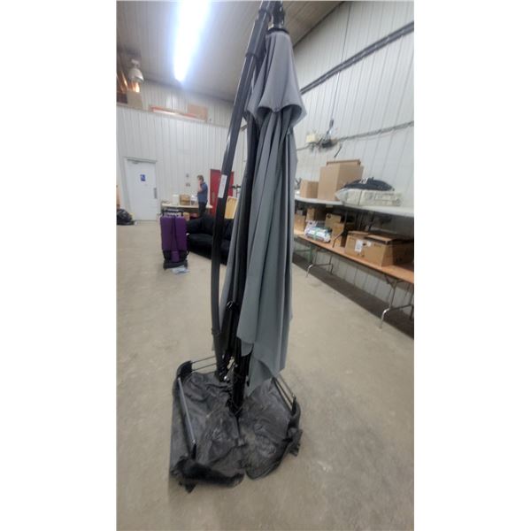 Gray Cantilever Patio Umbrella with Curved Support Pole and Weighted Base