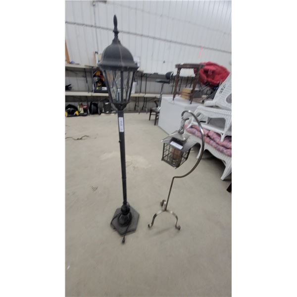 Black Outdoor Lamp Post with Lantern Top and Silver Hanging Lantern on Curved Stand