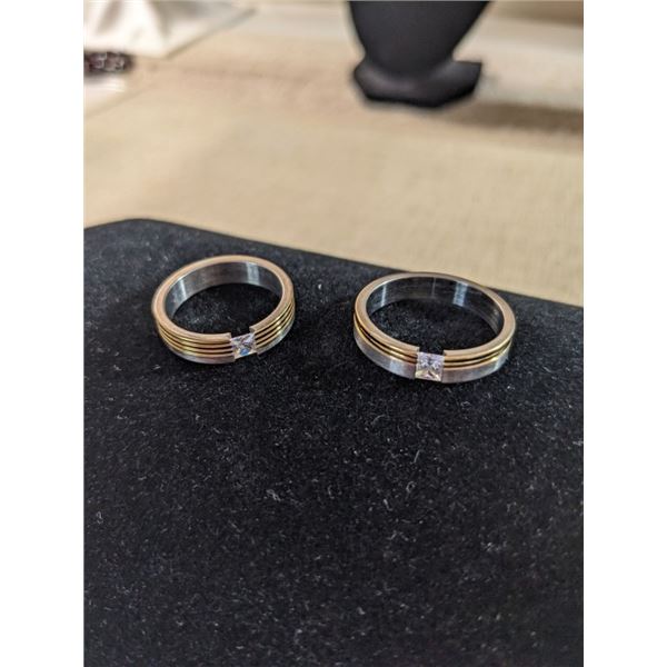 PAIR OF GOLD LINED W/ CZ STONES TITANIUM RINGS SIZE 8 AND 10