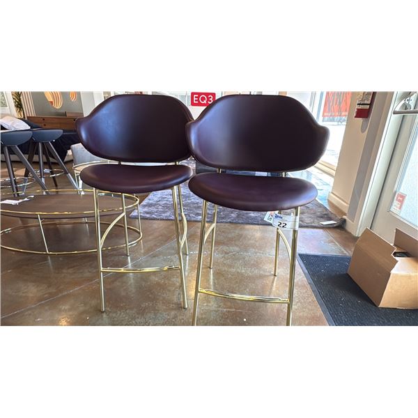 PAIR OF CALLIGARIS BRASS AND LEATHER HOLLY STOOLS. SOFTER BURGUNDY. NICELY DESIGNED AND COMFORTABLE.