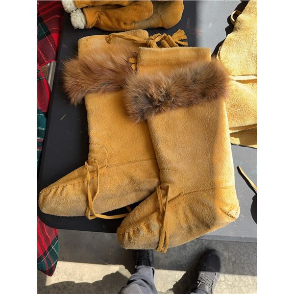 Several pieces of handmade winterwear: MOOSE HIDE LEATHER mittens lined with fleece, a pair of tall 