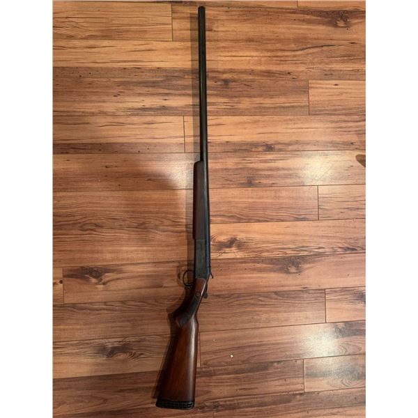 Cooey  model 34 single barrel shotgun featuring a wooden stock and blued metal receiver. The receive