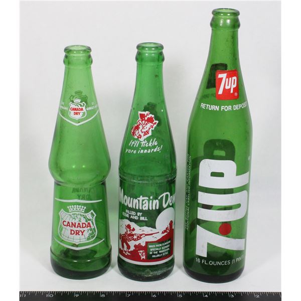 THREE VINTAGE BOTTLES MOUNTAIN DEW CANADA DRY 7UP