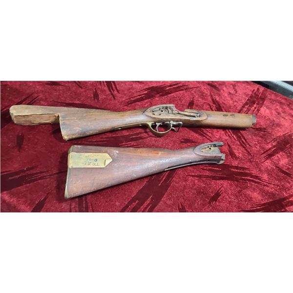 TWO BROKEN MUSKET STOCKS ONE MARKED TRAP DOOR