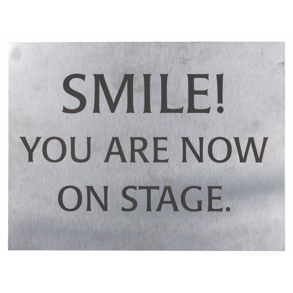 A "Smile, You Are Now on Stage" Cast Member Sign.
