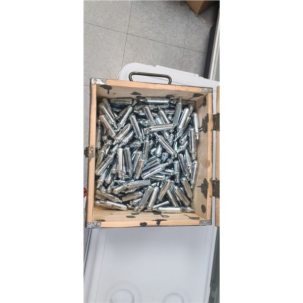 ROUGHLY 207 +/- CROSSMAN CO2 CARTRIDGES IN AMMO CRATE. NO SHIPPING!