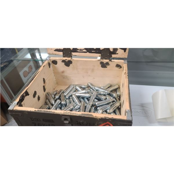 ROUGHLY 114 +/- CROSSMAN CO2 CARTRIDGES IN AMMO CRATE. NO SHIPPING!