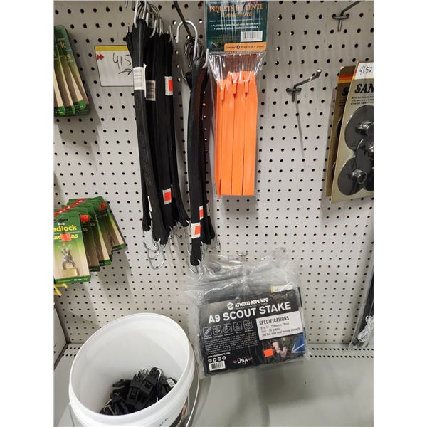 24 PLASTIC TENT PAGS, 5 PACKS OF A-9 SCOUT STAKES. 18-15" RUBBER BUNGY CORDS