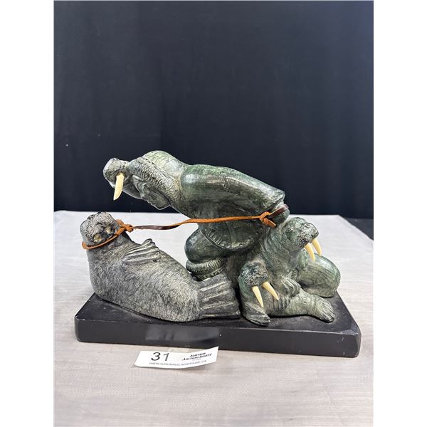 A Great Looking Sculpture Hunter and Walus One Walrus Missing its Tusks