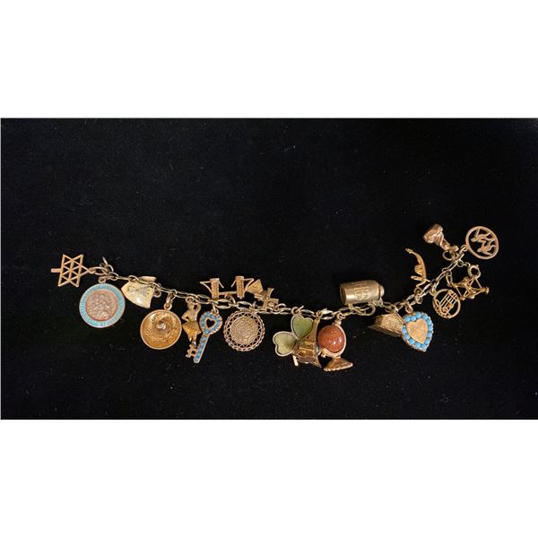 APPROX 14K CHARM BRACELET (7") WITH ASSORTED APPROX 9K-14K CHARMS (32.5G)