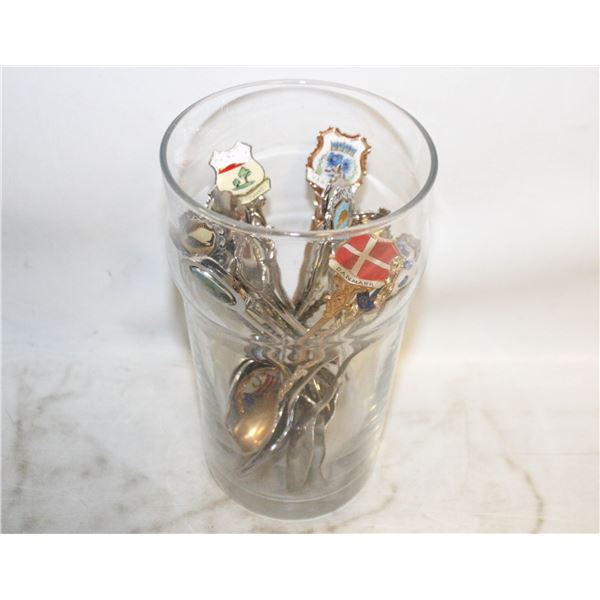 GLASS CUP FILLED WITH COLLECTABLE SPOONS